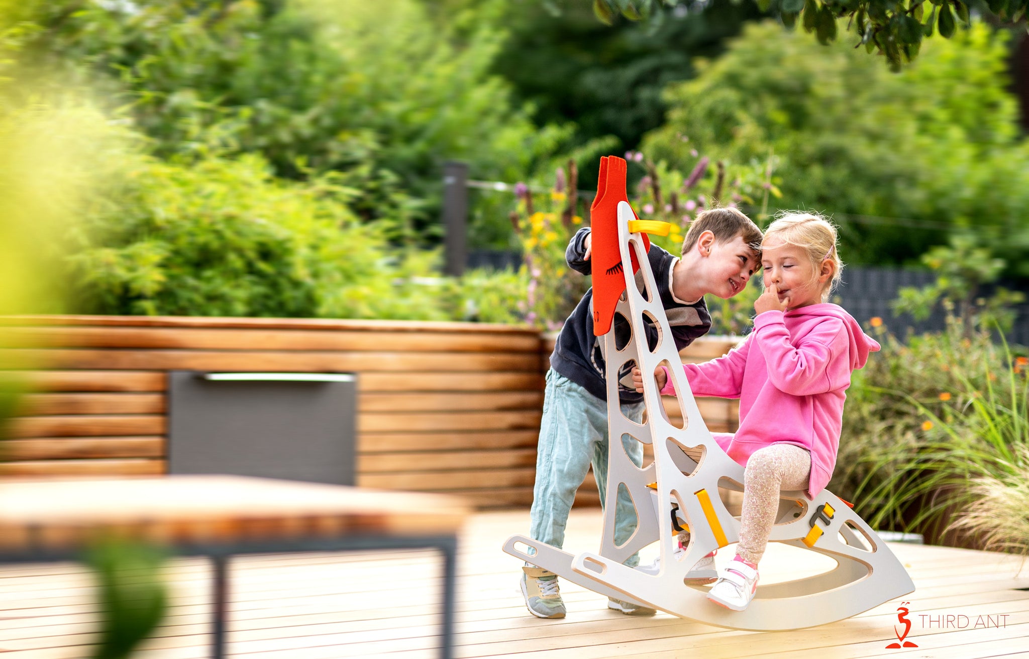 little girl on a gifee having fun together with a boy talking to her ear