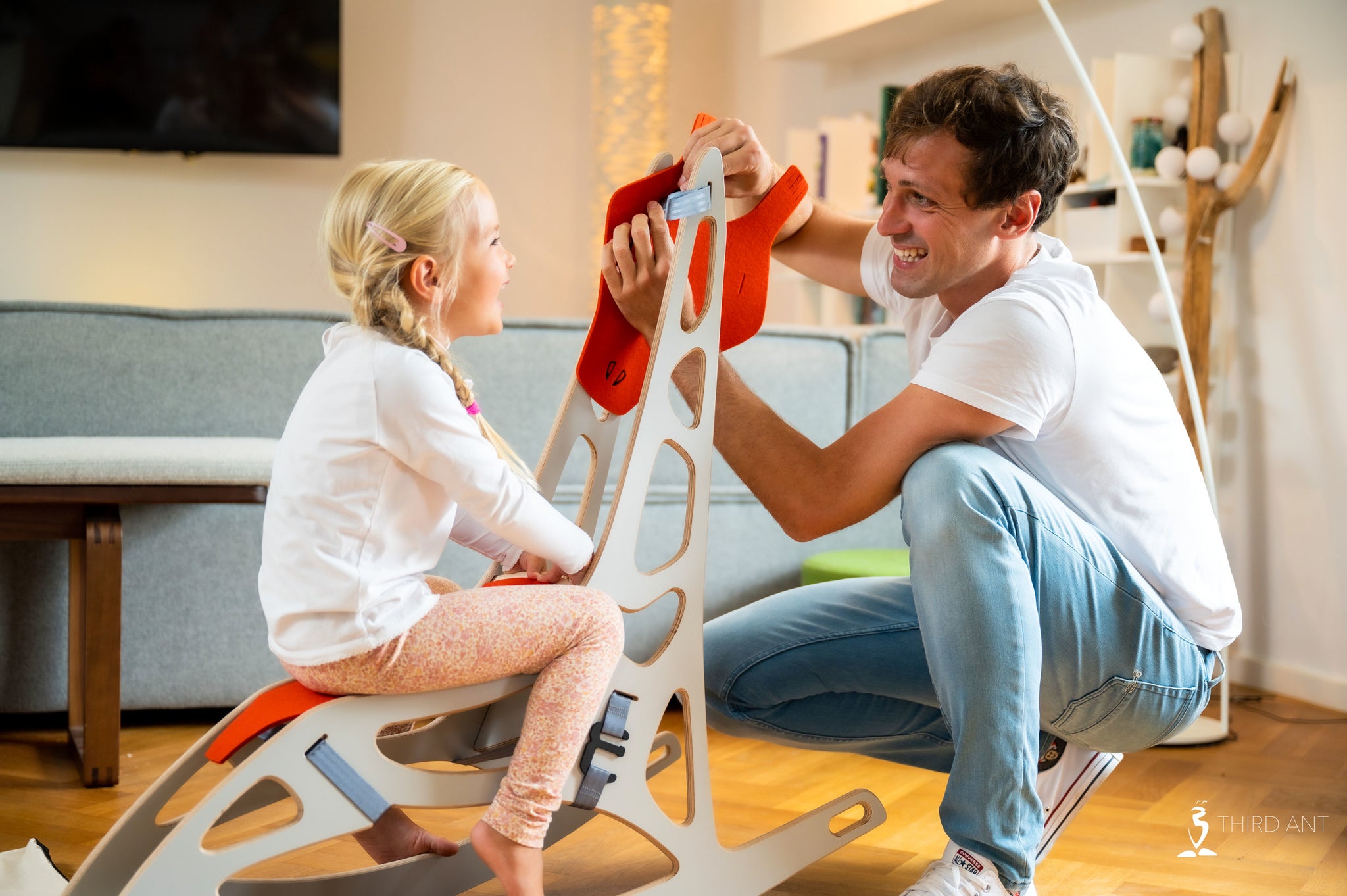 Father finishing the GiFee assembly while his dauther is already sitting on the GiFee 